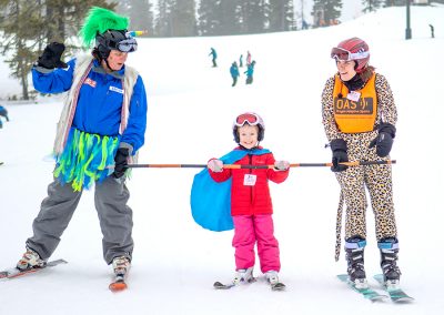 youth skier using bamboo pole wearing a costume