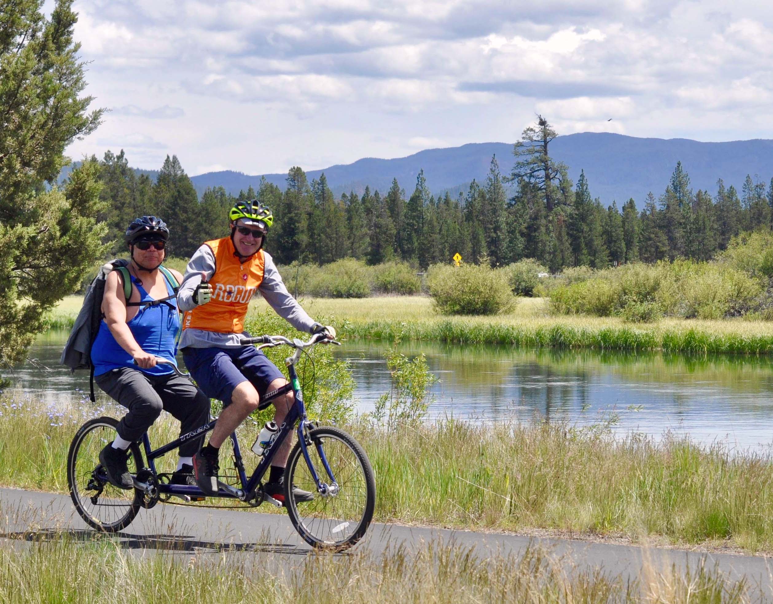Volunteer and participant on tandem cycle