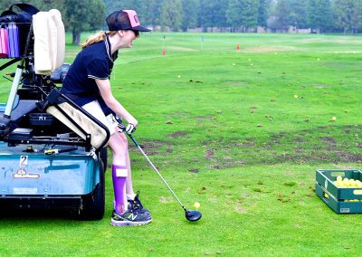 golfer using an adaptive golf cart