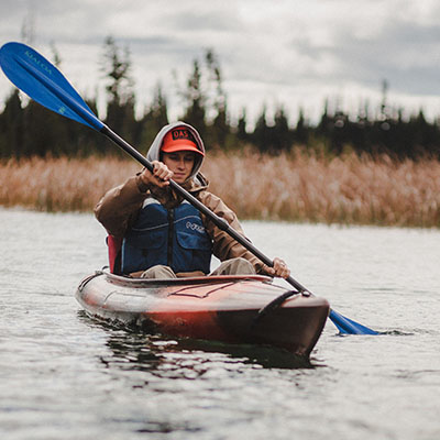 kayaker paddlin on lake