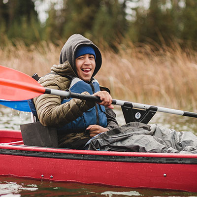 athlete kayaking using paddle support y bar on lake