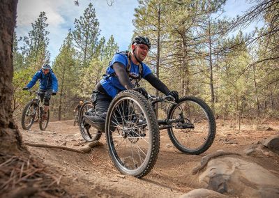 rider with a disability on a forward facing off road handcycle