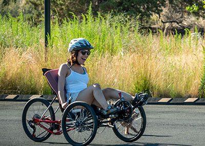 woman on recumbent trike riding outdoors