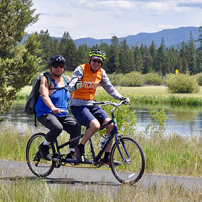 two athletes on tandem bicycle