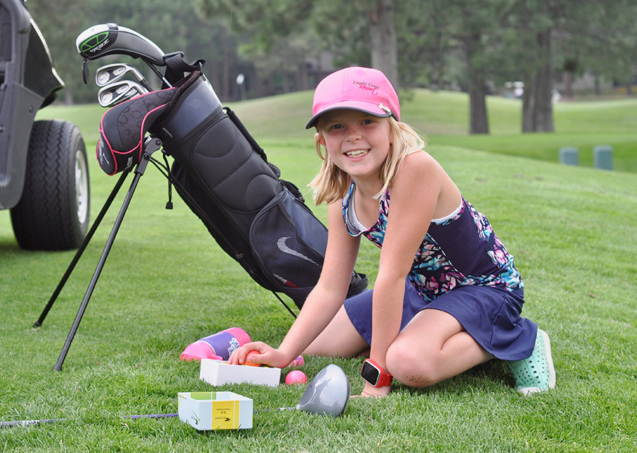 young golfer with bag of golf clubs