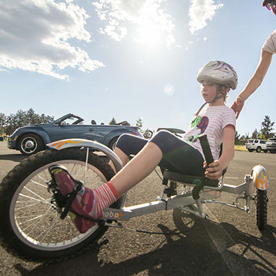 youth on recumbent tricycle