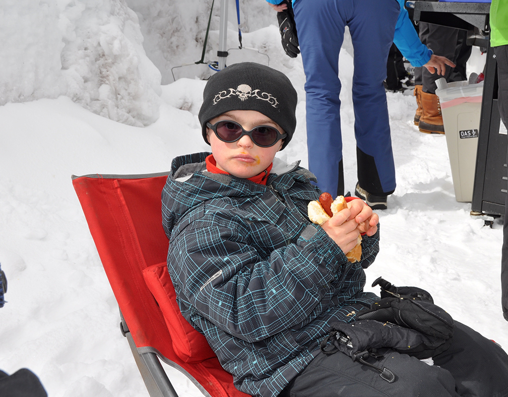 kiddo looking very serious about his hot dog at year end bbq