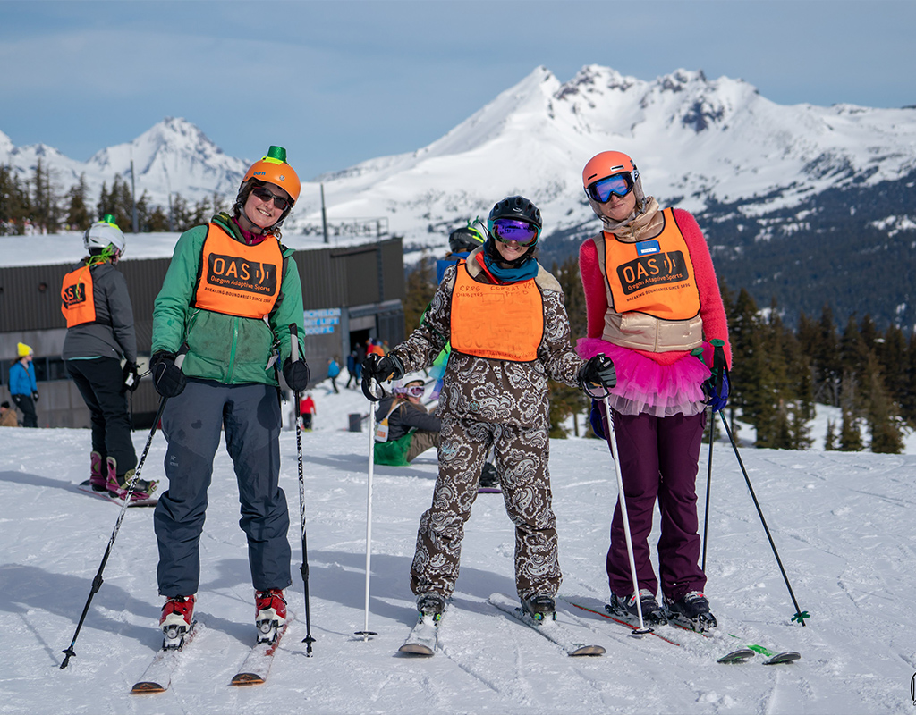 three skiers on the mountain on a beautiful bluebird ski day