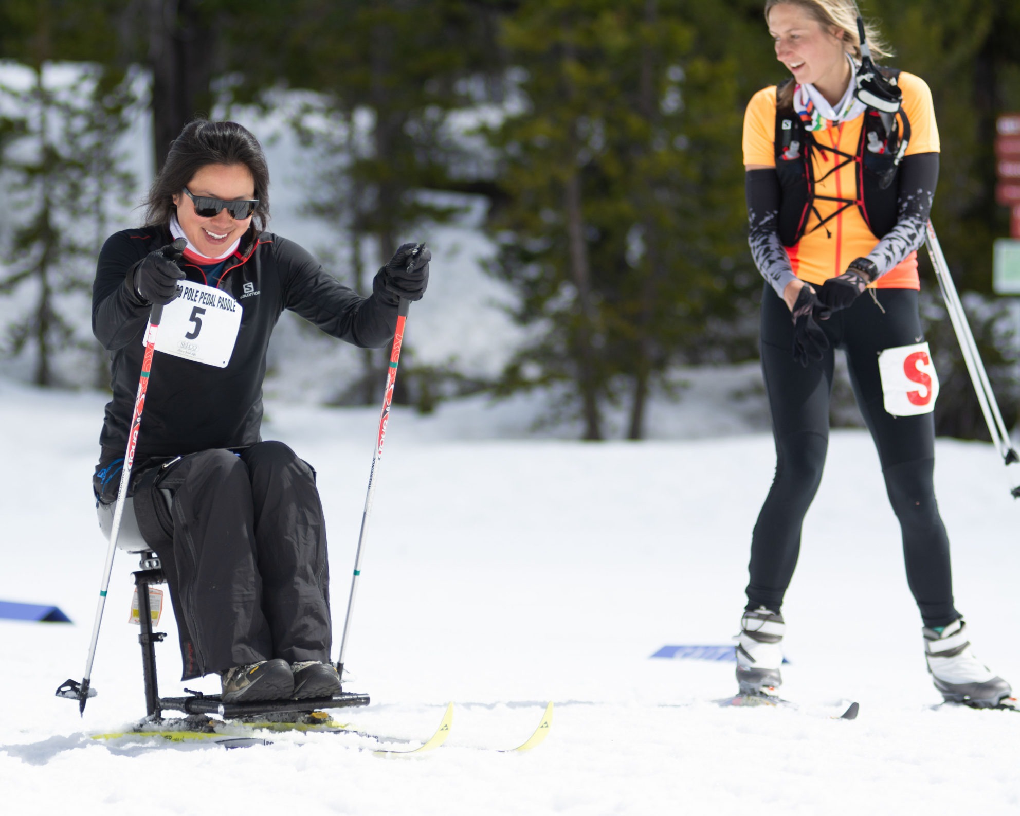 oas athlete anna pushing uphill in nordic sit ski at ppp