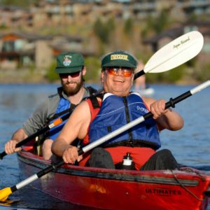 athlete darwin and VI guide paddling down river in PPP