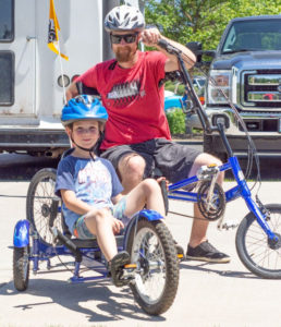 OAS athlete and son on recumbent bikes at Riverbend Park