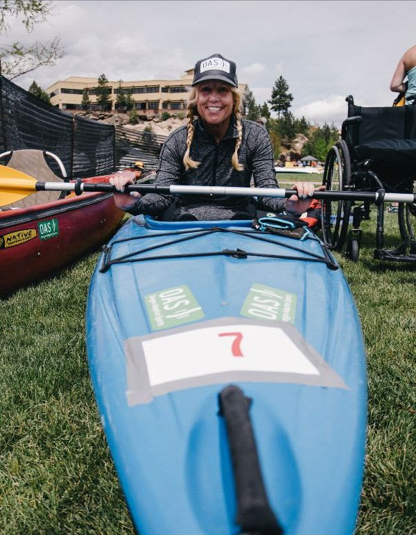 athlete sitting in kayak on grass, ready to be launched into the water for Pole Pedal Paddle raced