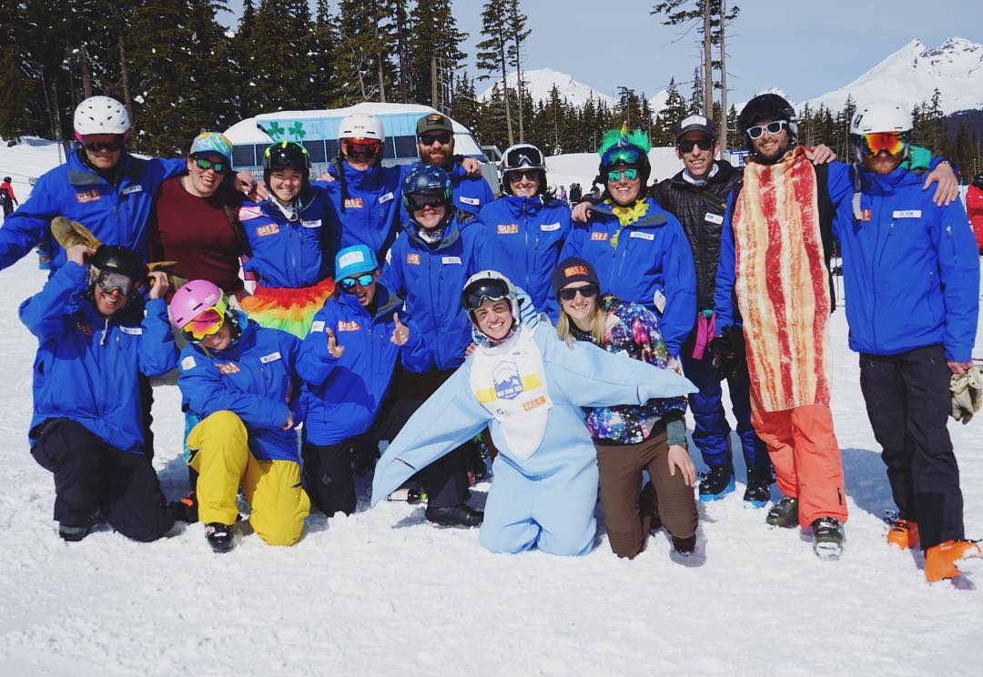 ski for all staff group shot with some in costume and some being goofy