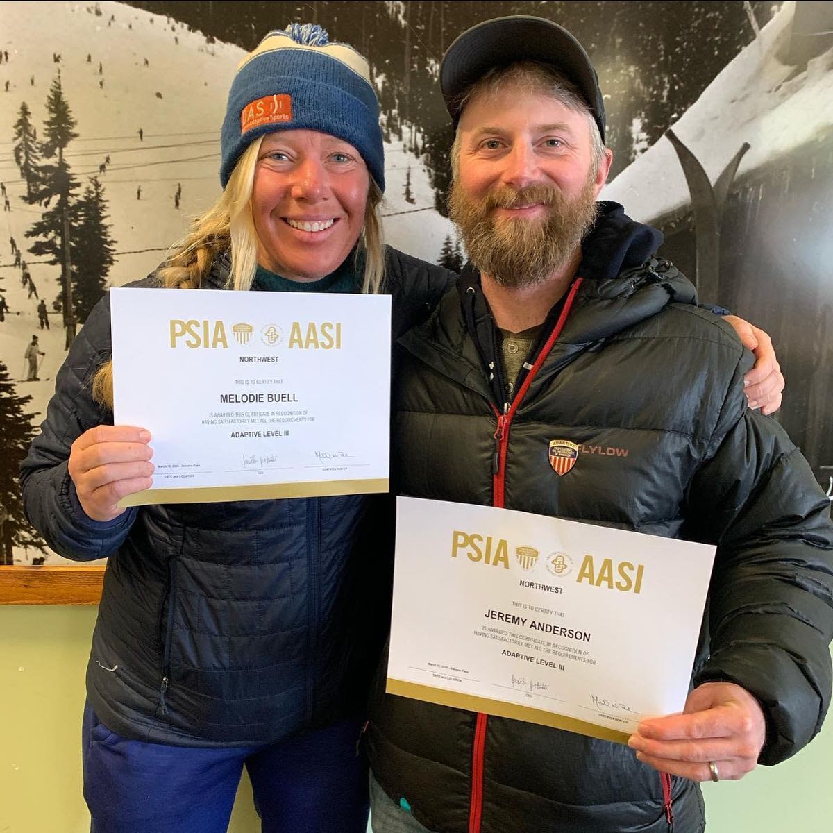 instructor melodie with jeremy of challenge alaska holding their certificates showing they are the first two people ever in the NW to get their PSIA level 3 adaptive certification