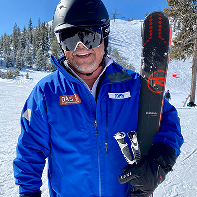 john morgan in a OAS uniform holding a pair of skis