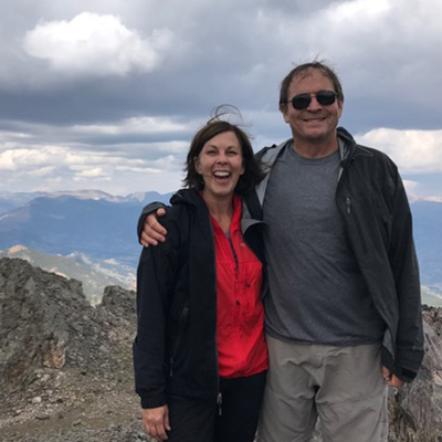 Traci Clautice Engle and her husband Alan Engle outside scenic vista in background