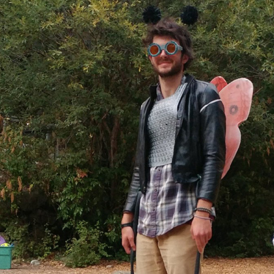 matt wearing sunglasses and a butterfly wings costume