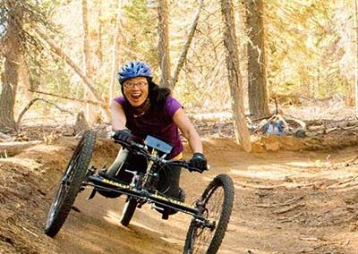 Anna riding an off road handcycle