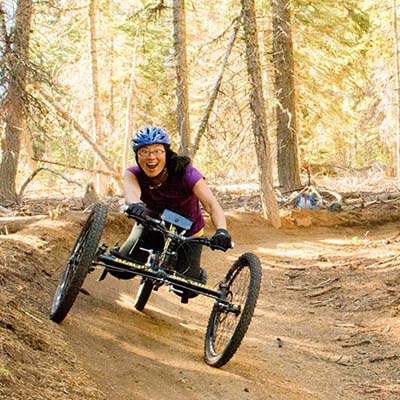 Anna riding an off road handcycle