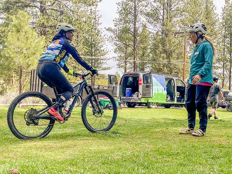 OAS coaching a woman learning to mountain bike
