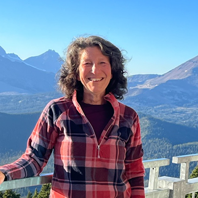 Jennifer smiling with mountains in the background