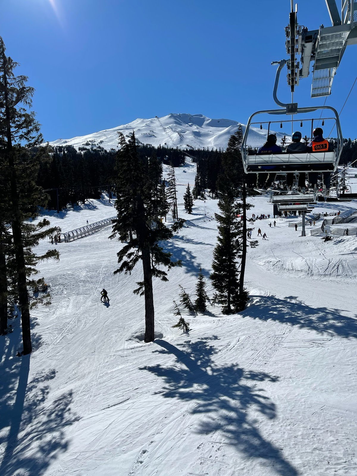 Dave riding the chairlift on a sunny day at Mt Bachelor