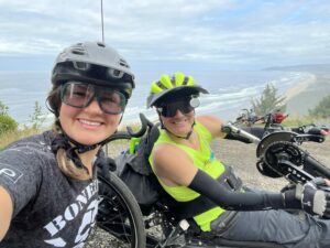 Max, adaptive athlete, and Hayley, OAS staff, taking a selfie together at the top of Lookout Cape during Cycle Oregon