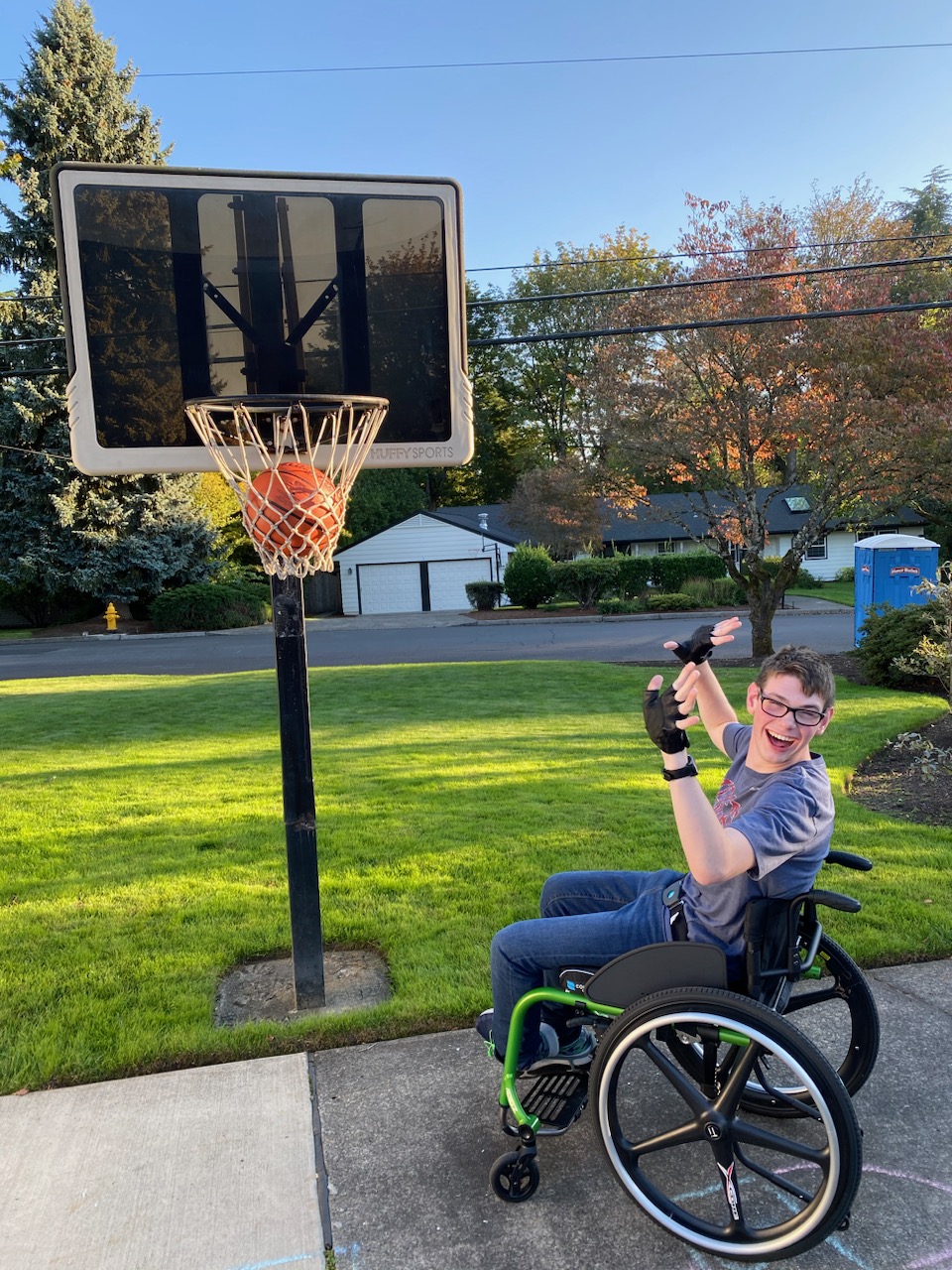 Kade in his wheelchair playing basketball