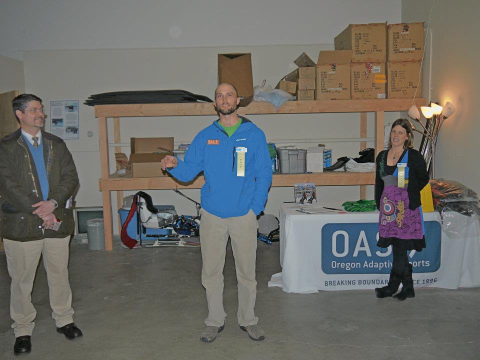 Jeremy Fox, OAS Winter Program Director at the time, stands center with partners beside him in a picture at the ribbon cutting for the OAS warehouse office space in 2012.