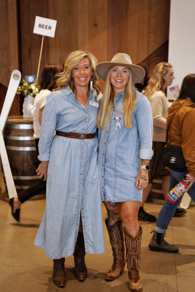 two women wearing jean dresses and boots, both witj light blonde hair