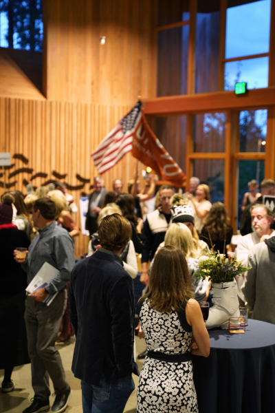 a photo of the crowd, with the O-A-S flag and the American flag both waving in the background.