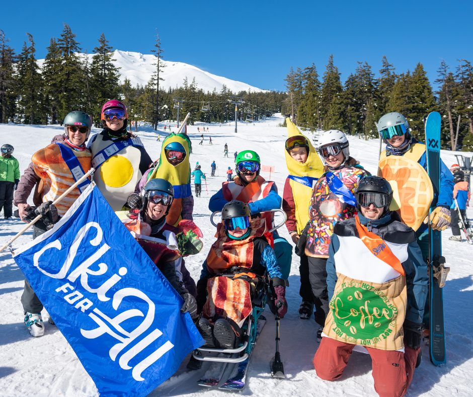 a group of people in various breakfast costumes poses for a photo with the blue ski for all flag.