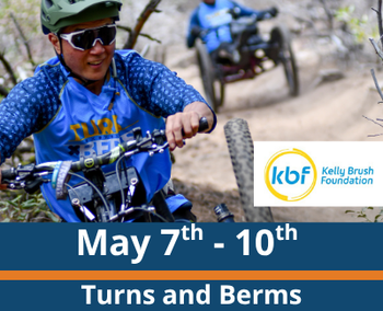 Trail riding scene; a person in a helmet and blue jersey rides an adaptive mountain bike in the foreground while another rider follows behind on the same dirt trail; visible text reads “May 7th - 10th,” “Turns and Berms,” and “With Kelly Brush Foundation,” with a circular “kbf Kelly Brush Foundation” logo.