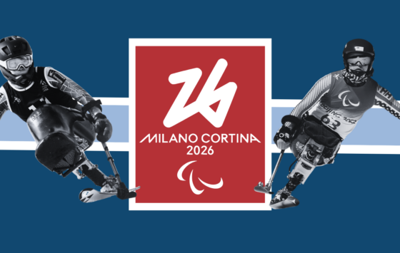 the milano cortina 2026 logo, with a red background sits between black and white outlines of Anna and Ravi monosking.