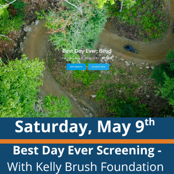Aerial forest trail scene; a person rides a mountain bike along a winding dirt path through dense green trees; visible text reads “Best Day Ever: Bend,” “Saturday, May 9th,” and “Best Day Ever Screening - With Kelly Brush Foundation.”