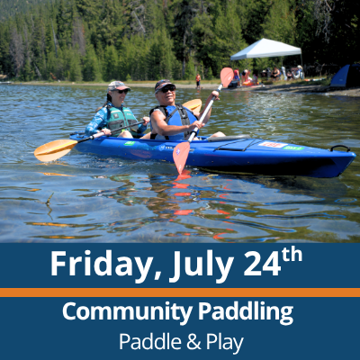 Friday, July 24th. Community Paddling. Paddle and Play. Two people paddle a blue tandem kayak across a lake, each holding a double-bladed paddle, with a forested shoreline