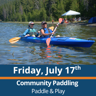 Friday, July 17th. Community Paddling. Paddle and Play. Two people paddle a blue tandem kayak across a lake, each holding a double-bladed paddle, with a forested shoreline