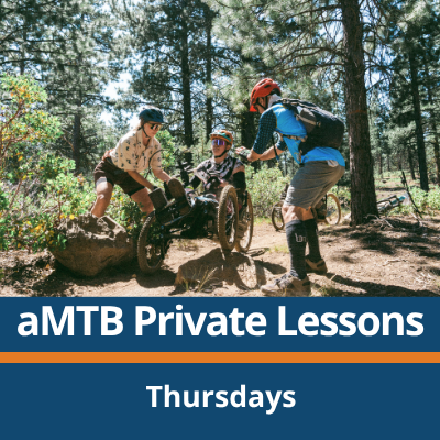 aMTB Private Lessons. Thursdays. A person rides a three-wheeled adaptive mountain bike over a log on a forest trail while two people on foot stand on either side and assist, surrounded by trees and dirt trail.