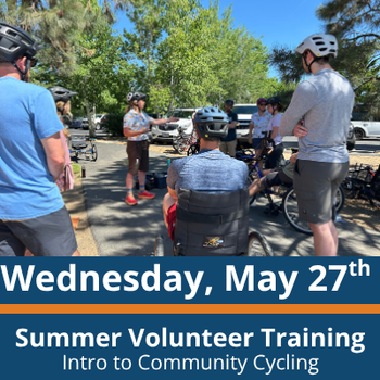 a group of people stand and sit in a circle with bikes and adaptive bikes, one person seated in an adaptive bike in the center facing an instructor who gestures while speaking; others stand nearby wearing helmets; text at the bottom reads “Wednesday, May 27th,” “Summer Volunteer Training,” and “Intro to Community Cycling.”
