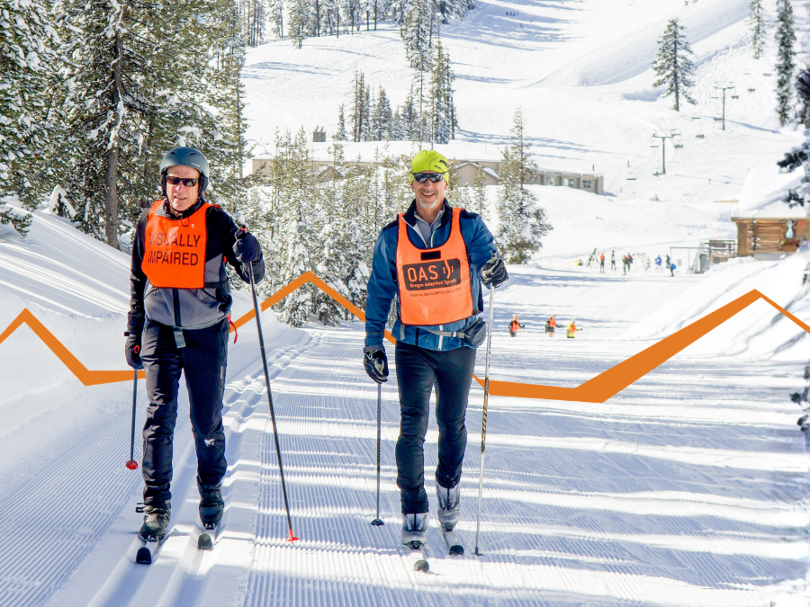 Two people cross-country ski side by side on a groomed trail, each using poles and moving forward with steady strides. One wears an orange vest that reads “VISUALLY IMPAIRED,” and the other wears an orange vest with O-A-S branding. Snow-covered trees, buildings, and skiers appear in the background, with an orange graphic line overlaying the scene.