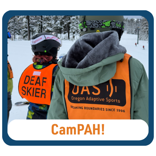 Graphic with text reading “CamPAH!” Two people stand on snow wearing helmets and bright orange vests. One vest reads “DEAF SKIER” and the other reads “OAS Oregon Adaptive Sports.” Snow-covered trees and skiers are visible in the background.