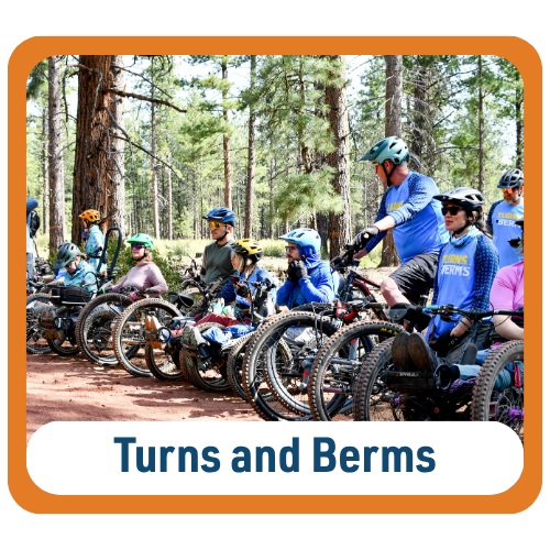 Graphic with text reading “Turns and Berms.” A group of cyclists gathers on a forest trail with adaptive mountain bikes, off-road handcycles, and upright mountain bikes. The riders wear helmets and wait together among tall pine trees.